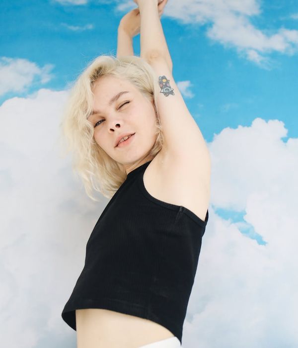Smiling woman stretching outdoors, feeling energetic and free.